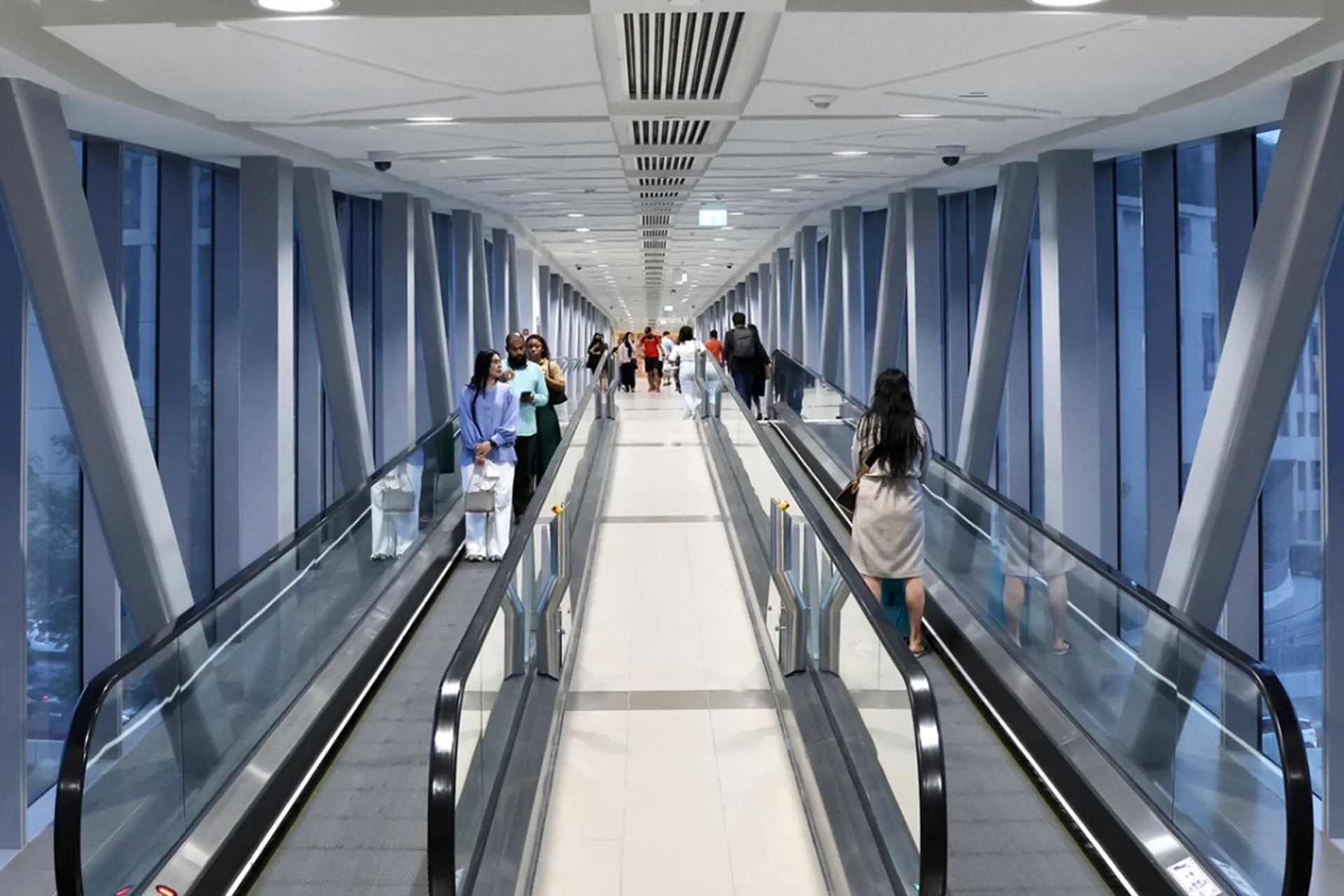 The gleaming escalator at Dubai Mall, inviting visitors to ascend into a world of luxury retail and entertainment.